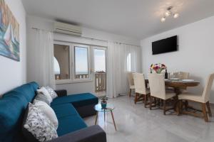 Villa Anja في سبليت: غرفة معيشة مع أريكة زرقاء وطاولة