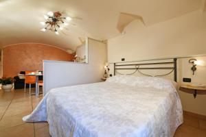 a bedroom with a large white bed and a table at Vista Sulle Langhe in Carrù