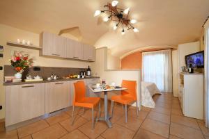a kitchen with orange chairs and a table in a kitchen at Vista Sulle Langhe in Carrù