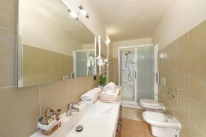 a bathroom with a sink and a toilet and a mirror at Vista Sulle Langhe in Carrù