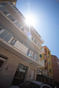 a building with the sun shining on it at Residenza Ca’ Vittoria in Chioggia