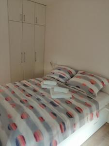 a bedroom with a bed with red and white pillows at Portus in Zagreb