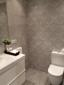 a bathroom with a toilet and a sink at Casa da Xastra in Vimianzo +15 photos