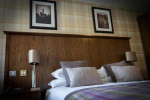 
a hotel room with a bed and two lamps at Beaufort Hotel in Inverness

