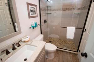 a bathroom with a toilet and a sink and a shower at Winterplace 3 Br- Plenty Of Bedding- Great For Families Condo in Ludlow +16 photos