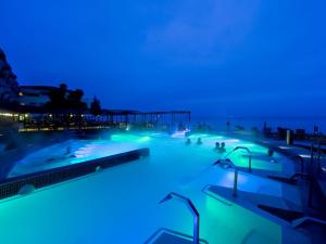 a swimming pool lit up with blue lights at Grand Hotel Terme Sirmione in Sirmione