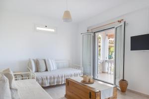 a living room with a couch and a table at Pernari Apartments in Spartià