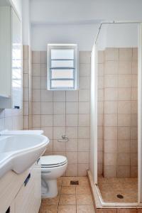 a bathroom with a sink toilet and a window at Pernari Apartments in Spartià +52 photos