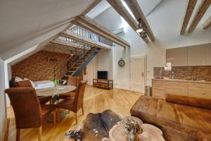 a living room with a table and a couch at Aapartamentoos in Bratislava