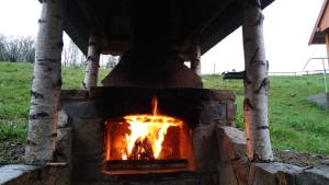 a stone oven with a fire in it at Zacharovany Karpaty in Slavske