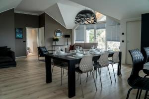 a dining room with a black table and chairs at Om Apartments in Reykjavík