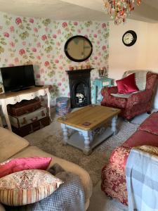 a living room with a table and a fireplace at Clarke’s Farm in Heighington