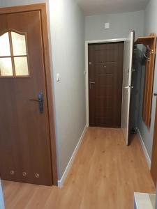 an empty room with a door and a hallway at Apartament Puck in Puck