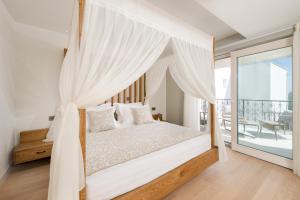 una camera da letto con letto a baldacchino e balcone di Villa Basca a Baška Voda
