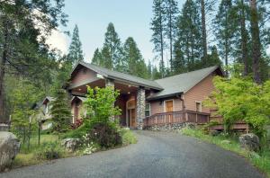 a house in the woods with a driveway at 2A The Terry Cabin in North Wawona