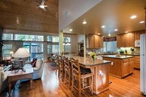 an open kitchen and living room with wooden cabinets at 2A The Terry Cabin in North Wawona