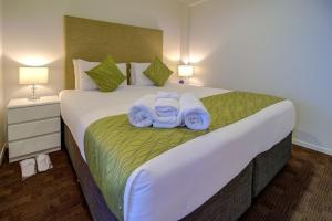 Cama o camas de una habitación en The Quadrant Hotel & Suites
