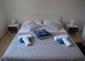a bedroom with a large bed with towels on it at Vacation home Kairos in Sumartin