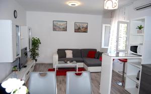 a living room with a couch and a table at Vacation home Kairos in Sumartin