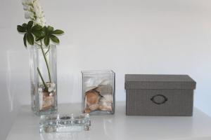 a vase with stones and a box next to it at Casa da Maçã in Sesimbra
