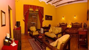 a living room filled with furniture and a fireplace at Hotel Marqueses in Cusco
