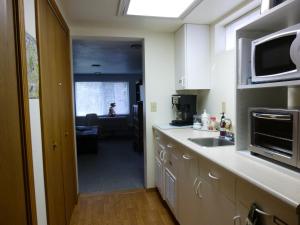 a kitchen with a sink and a microwave at Linda's By The Lake in Maple Valley