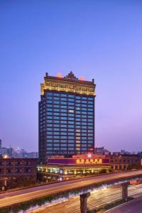 a tall building with lights on top of it at Nanyang King's Gate Hotel in Guangzhou