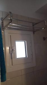 a window in a bathroom with a shower curtain at Seaside studio for 3 people - Alykes beach in Dhimínion