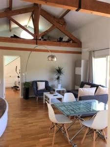 a living room with a table and chairs at Appartements Les Pesquiers 2 Hyères Plage in Hyères