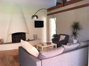 a living room with a couch and a fireplace at Appartements Les Pesquiers 2 Hyères Plage in Hyères