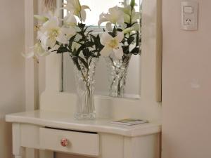 a vase of flowers on a table in a room at AE Buenos Aires in Buenos Aires