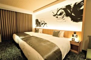 Кровать или кровати в номере Homm Stay Nagi Sanjo Kyoto By Banyan Group