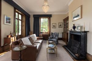 a living room with a couch and a fireplace at Prospect Country House & Restaurant in Richmond