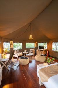 a room with beds and chairs in a tent at Flameback Eco Lodge in Tissamaharama