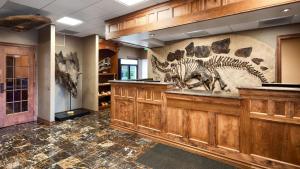 a large room with a museum with skeletons on the wall at Best Western Denver Southwest in Lakewood