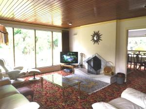 a living room with a couch and a fireplace at Kingsmills Cottages in Artrea
