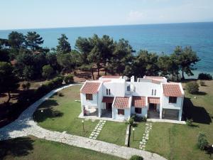 an aerial view of a house with the ocean at Summerday Villa Private Beach in Nea Iraklia
