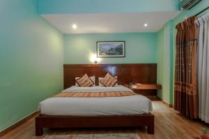 a bedroom with a bed in a room at Hotel Peace Plaza in Pokhara