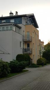 a large building with a balcony on top of it at Siesta Apartments in Sopot