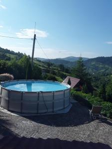 a large swimming pool in the middle of a yard at Hotel Fortetsya in Slavske