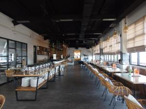a restaurant with tables and chairs in a room at The City Hotel in Ambon