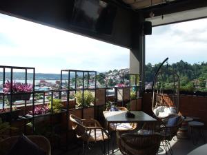a restaurant with a view of the city from the balcony at The City Hotel in Ambon