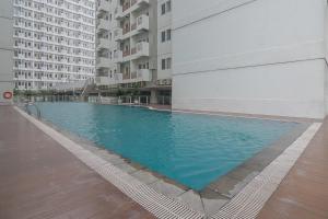 a swimming pool in the middle of a building at RedDoorz Apartment @ Sentul Tower in Bogor