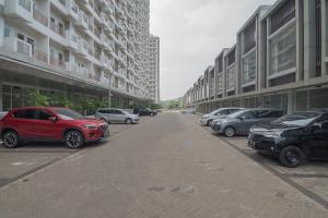 a row of cars parked on the side of a building at RedDoorz Apartment @ Sentul Tower in Bogor