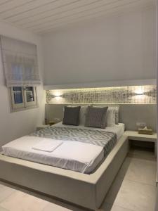 a bedroom with a large bed in a room at Astra Studios in Astypalaia Town