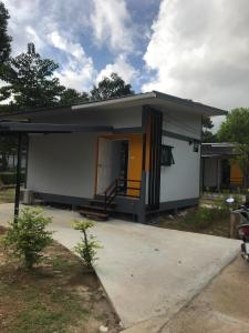 a small house with a yellow and white at Fine Times Resort in Ko Chang