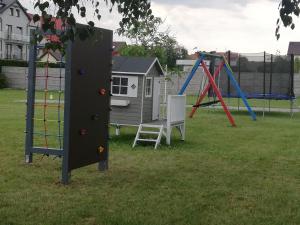 a group of playground equipment in a park at Agromarko in Ustronie Morskie