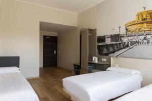 
سرير أو أسرّة في غرفة في B&B Hotel Roma Pietralata Tiburtina
