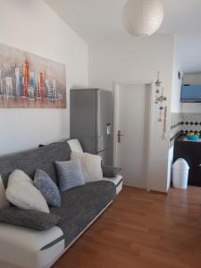 a living room with a couch and a painting on the wall at Doana Apartments in Vir