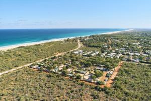 a large body of water with palm trees at RAC Cable Beach Holiday Park in Broome